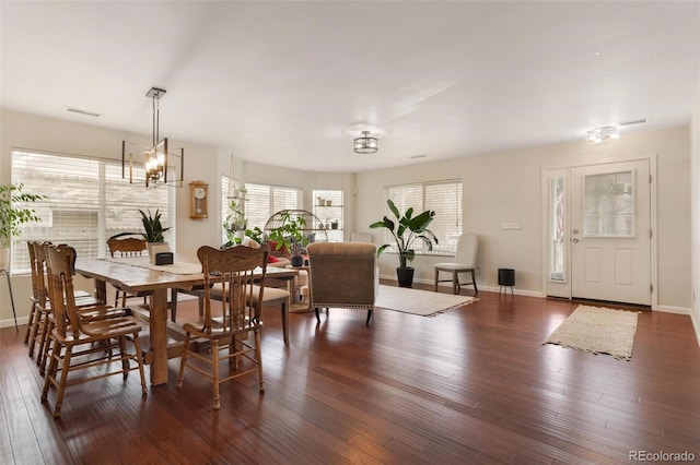 11885 Helena St, Commerce City, CO 80022 - dining room with plenty of natural light, dark wood-type flooring, and an inviting chandelier