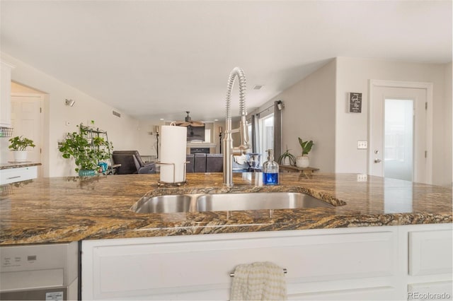 11885 Helena St, Commerce City, CO 80022 - kitchen featuring white cabinetry, dark stone counters, and sink