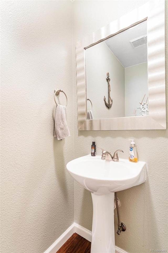 11885 Helena St, Commerce City, CO 80022 - bathroom featuring hardwood / wood-style floors