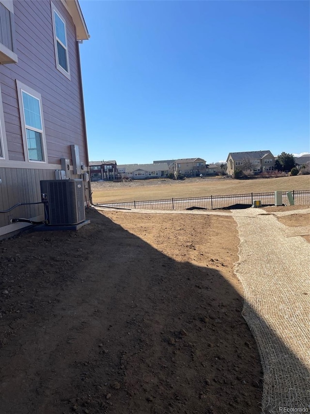 view of yard featuring central air condition unit and fence private yard