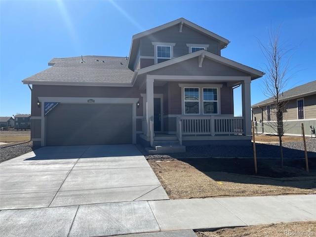 view of front of property featuring an attached garage, driveway, a porch, and roof with shingles