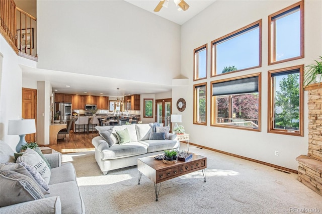 942 Xenon Ct, Golden, CO 80401 - living area with high vaulted ceiling, plenty of natural light, a ceiling fan, and light carpet