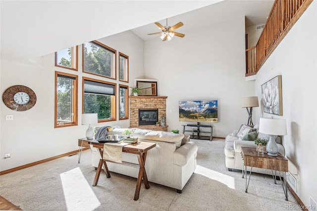 942 Xenon Ct, Golden, CO 80401 - living area with a high ceiling, light carpet, a fireplace, and ceiling fan