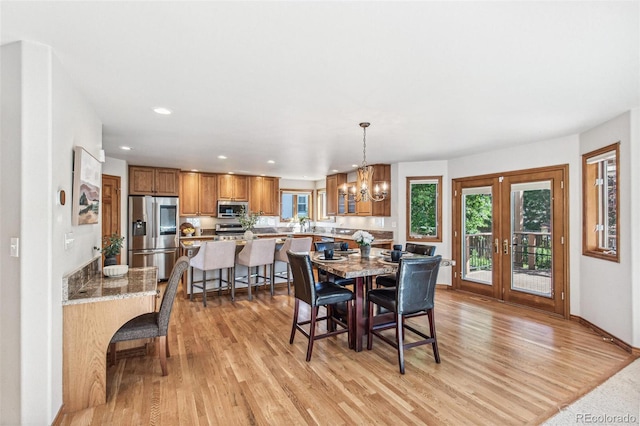 942 Xenon Ct, Golden, CO 80401 - dining space featuring french doors, light wood-style floors, recessed lighting, and a chandelier