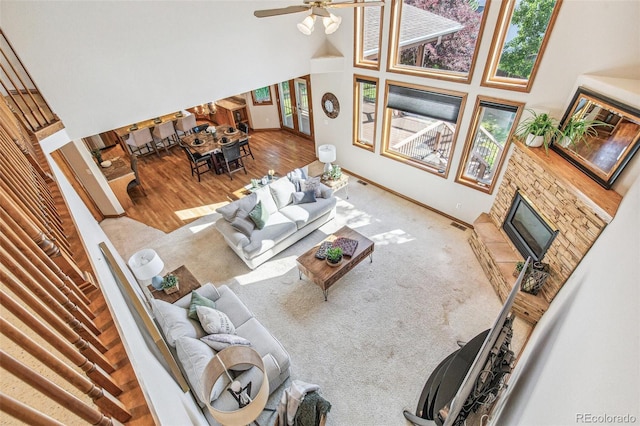 942 Xenon Ct, Golden, CO 80401 - living area featuring a fireplace, a high ceiling, wood finished floors, and a ceiling fan