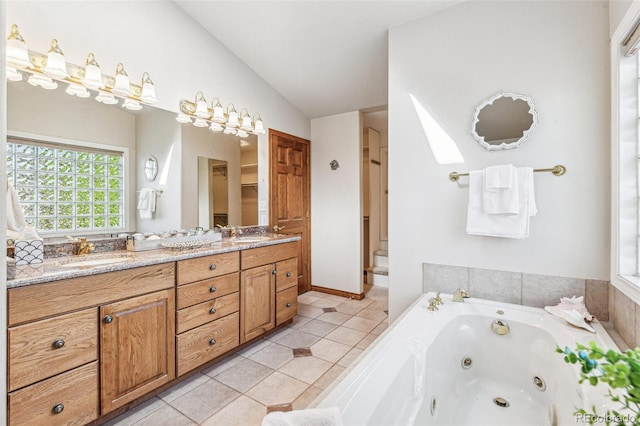 942 Xenon Ct, Golden, CO 80401 - full bath featuring lofted ceiling, double vanity, a whirlpool tub, and tile patterned floors