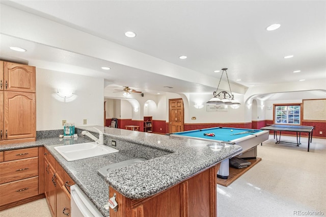 942 Xenon Ct, Golden, CO 80401 - recreation room with arched walkways, a wainscoted wall, recessed lighting, and a ceiling fan