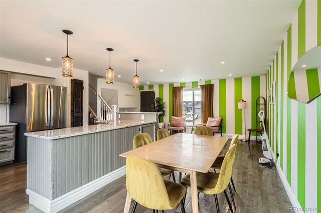 dining area with wood-type flooring, baseboards, recessed lighting, and wallpapered walls