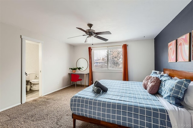 carpeted bedroom with ensuite bathroom, baseboards, and ceiling fan
