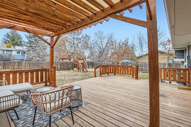 wooden terrace with a fenced backyard