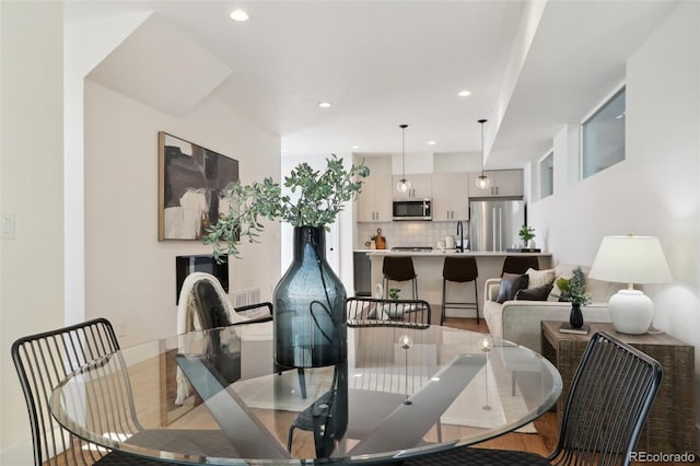 dining area with recessed lighting, baseboards, and wood finished floors