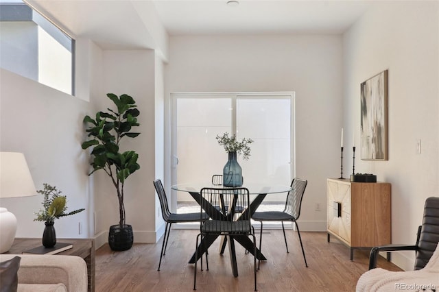 dining room with baseboards and wood finished floors