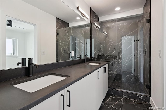 full bathroom featuring recessed lighting, marble finish floor, a marble finish shower, and a sink