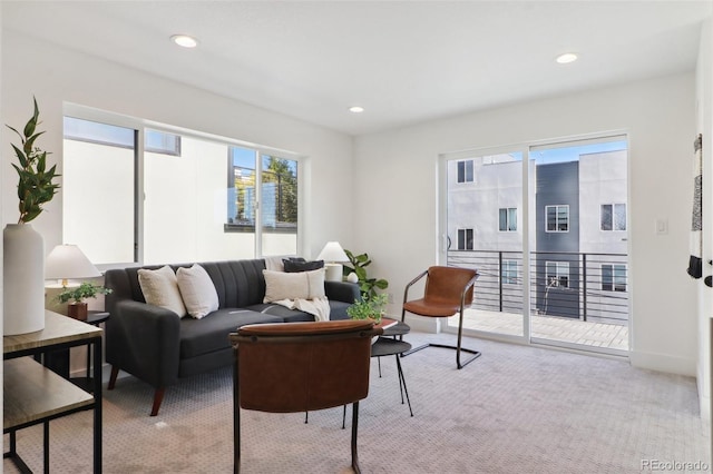 carpeted living room with recessed lighting and baseboards