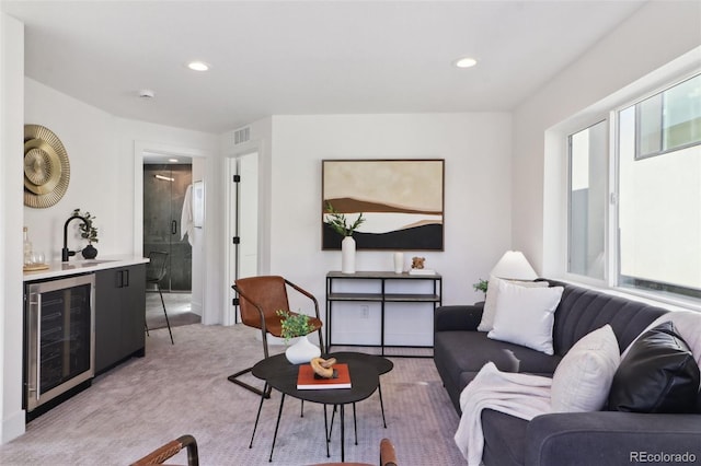 living room featuring beverage cooler, recessed lighting, a dry bar, and light carpet