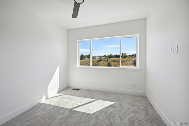 unfurnished room featuring visible vents, ceiling fan, baseboards, and carpet floors