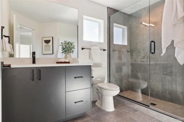 full bathroom featuring a shower stall, toilet, and vanity