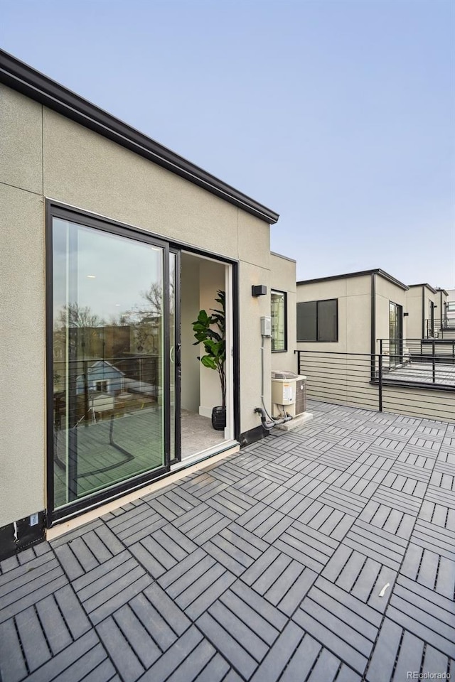 view of patio featuring a balcony and central AC unit