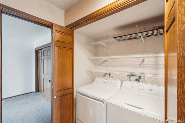 laundry room featuring laundry area, light colored carpet, and washing machine and clothes dryer