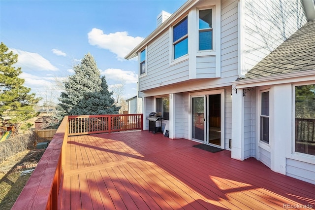 wooden terrace with a grill