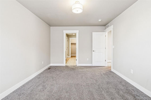 unfurnished bedroom with light colored carpet