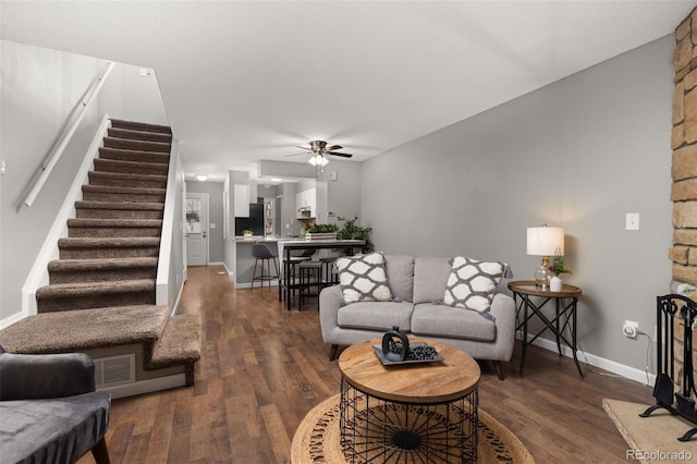 living room featuring dark hardwood / wood-style floors and ceiling fan