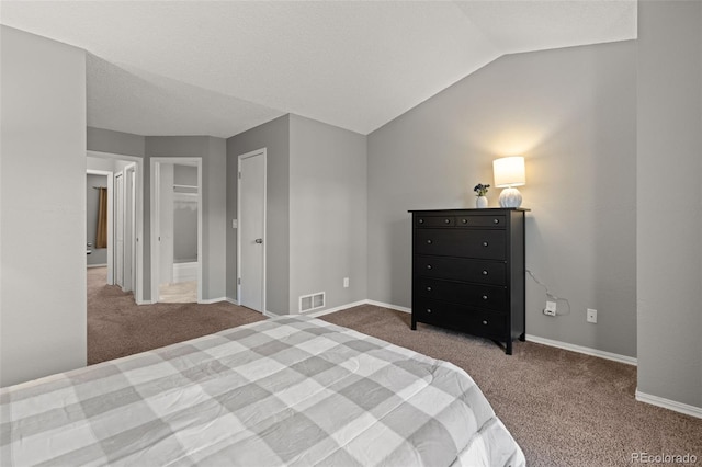 carpeted bedroom featuring vaulted ceiling and a closet