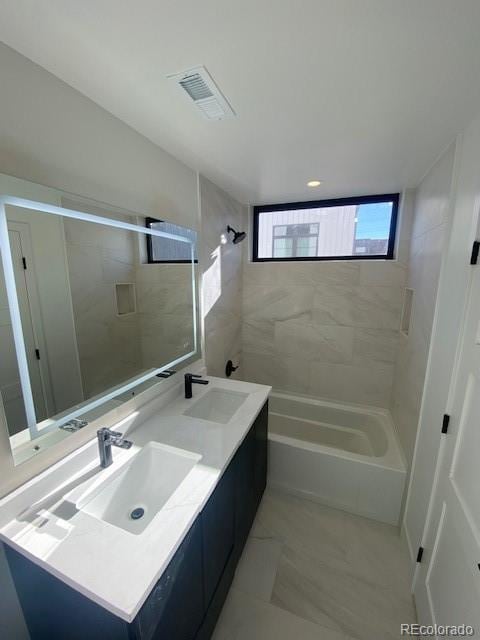 bathroom with double vanity, visible vents, a sink, and shower / bathing tub combination