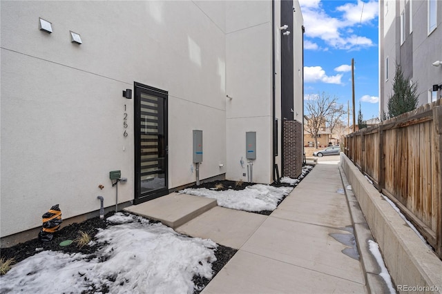 view of property exterior featuring fence and stucco siding