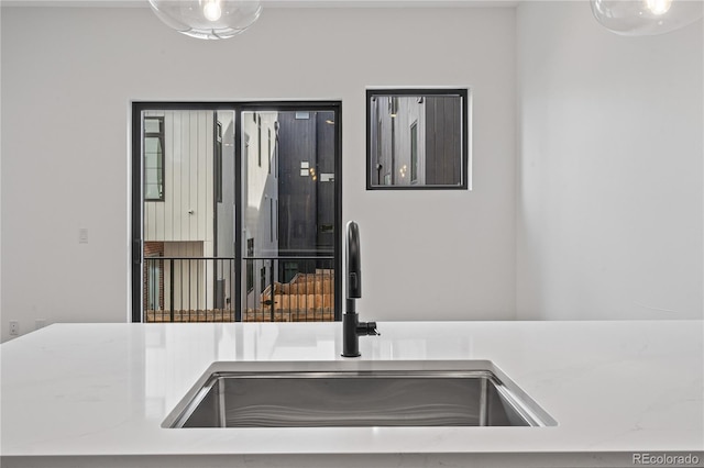 interior space with light countertops and a sink