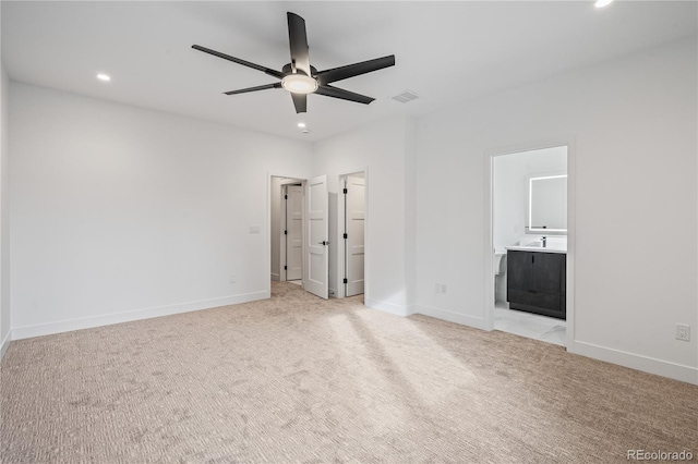 unfurnished bedroom with recessed lighting, light carpet, and baseboards