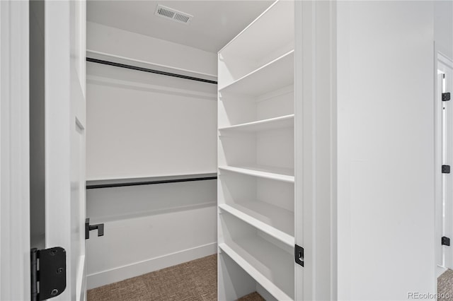 walk in closet with carpet flooring and visible vents