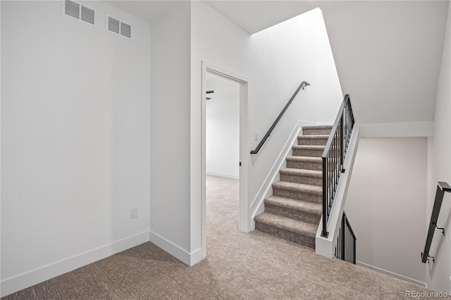 staircase with carpet, visible vents, and baseboards