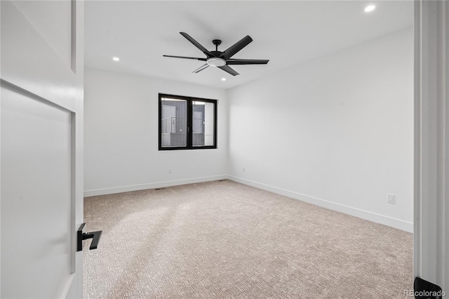 spare room with recessed lighting, carpet, a ceiling fan, and baseboards