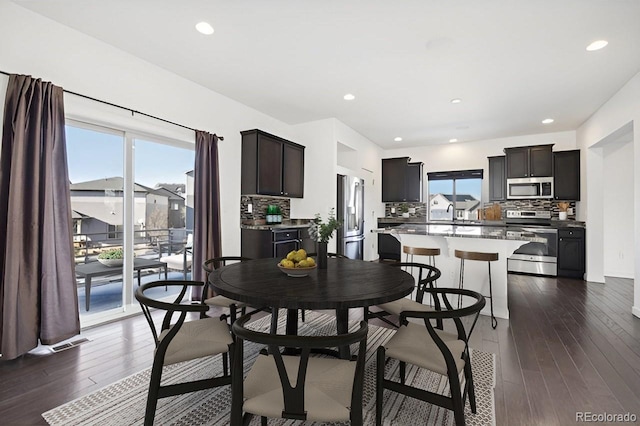 dining space featuring dark hardwood / wood-style floors and a healthy amount of sunlight