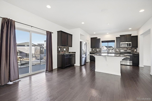 kitchen with a wealth of natural light, dark wood-type flooring, and stainless steel appliances