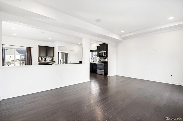 unfurnished living room featuring dark hardwood / wood-style flooring and sink