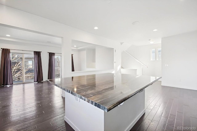 kitchen with a spacious island and dark wood-type flooring