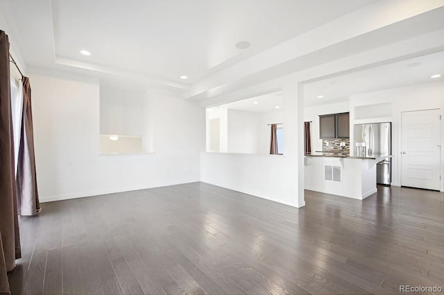 unfurnished living room featuring dark wood-type flooring