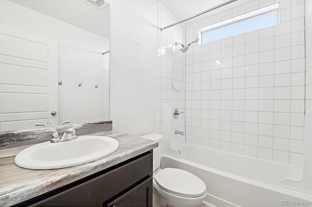 full bathroom featuring vanity, toilet, and tiled shower / bath