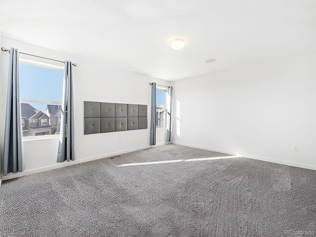 unfurnished bedroom with carpet and multiple windows