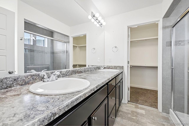 bathroom featuring vanity and an enclosed shower