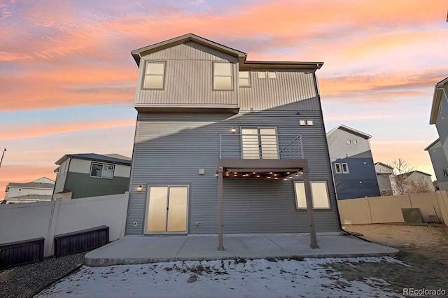 snow covered property with a balcony