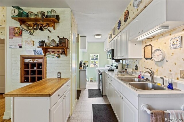 7750 W 5th Ave, Lakewood, CO 80226 - kitchen with electric range, a sink, and white cabinets
