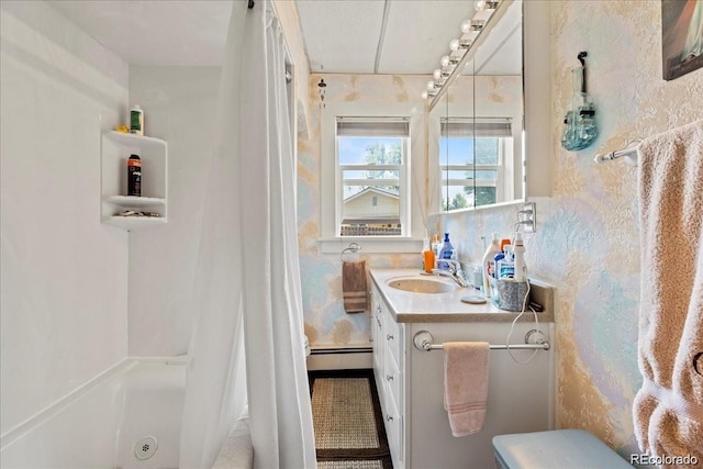 7750 W 5th Ave, Lakewood, CO 80226 - full bathroom featuring a baseboard heating unit and vanity