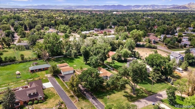 7750 W 5th Ave, Lakewood, CO 80226 - aerial view of property's location with a mountainous background and nearby suburban area