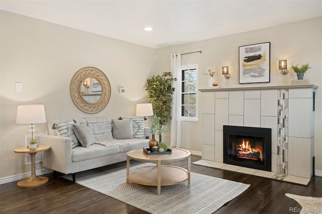 living room with hardwood / wood-style floors and a tile fireplace