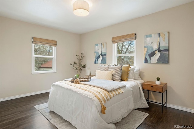 bedroom featuring dark wood-type flooring and multiple windows