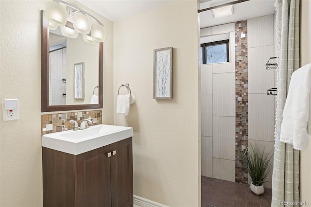 bathroom featuring vanity and backsplash