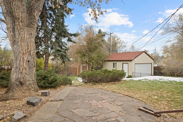 view of front of home with a shed and a front lawn